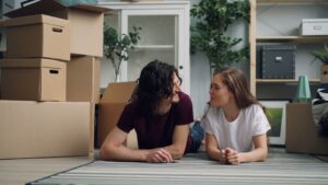 A couple looking at happily at each other after buying a new home